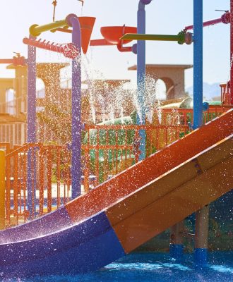 Colorful slides in the waterpark close up. Aquapark sliders with pool